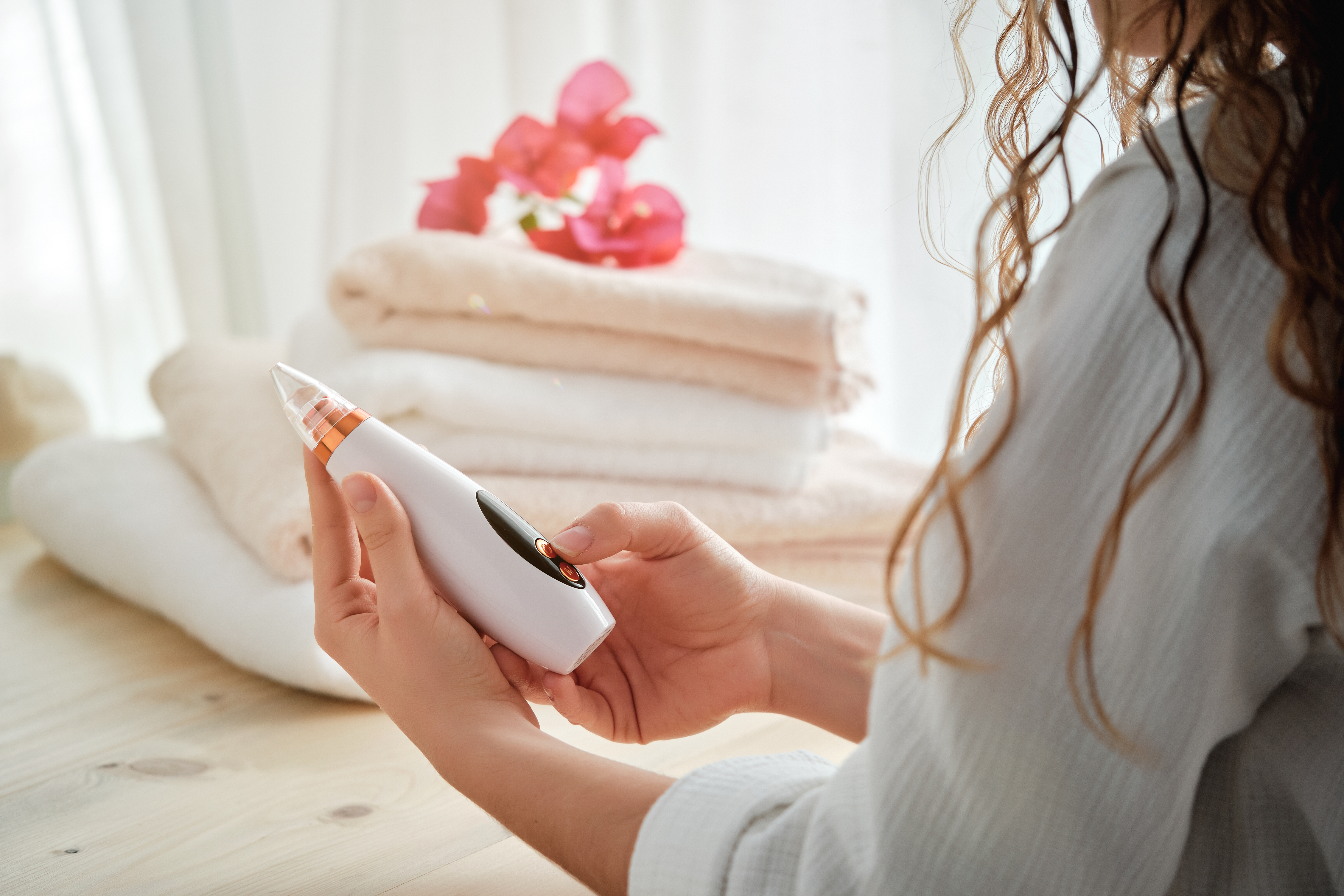 Anonymous woman turning on acne cleaner
