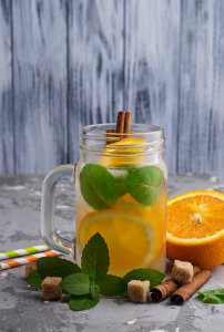 Detox water with orange, mint and cinnamon in jar