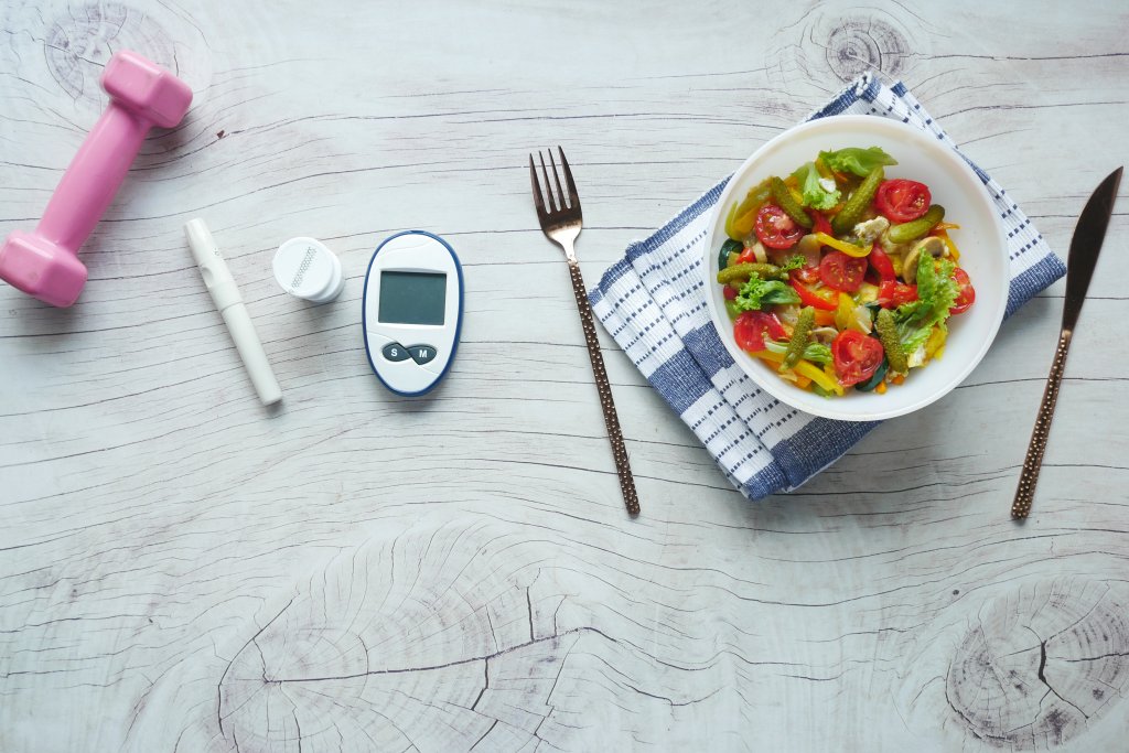 diabetic measurement tools and healthy food on table