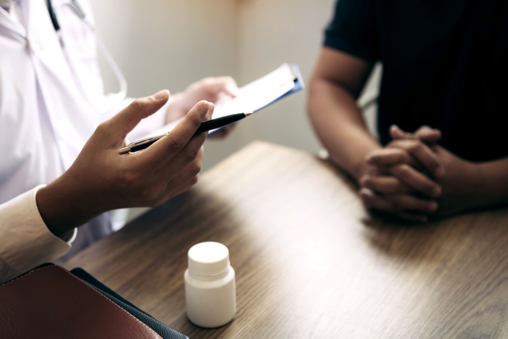 Menopausal Acne-Doctor talking to the patient about menopause and treatment in future.