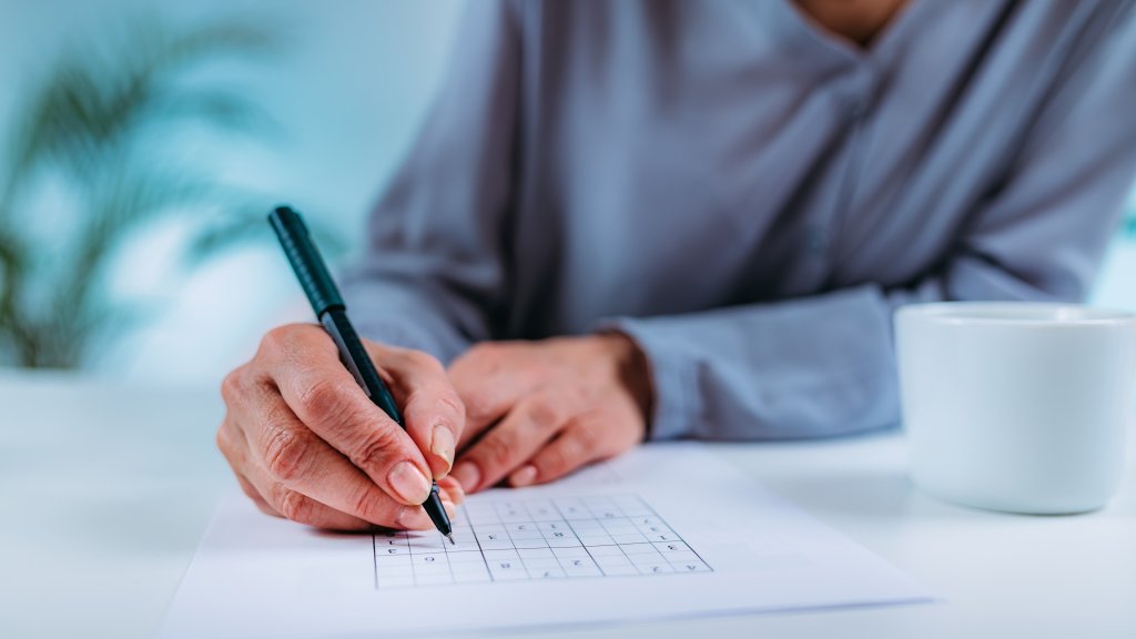 Ketosis0Senior Woman Solving Sudoku Puzzle. Cognitive Therapy for Senior Woman.