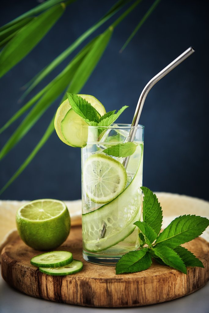 Weight -Glass of water with kiwi, lime and mint on dark background