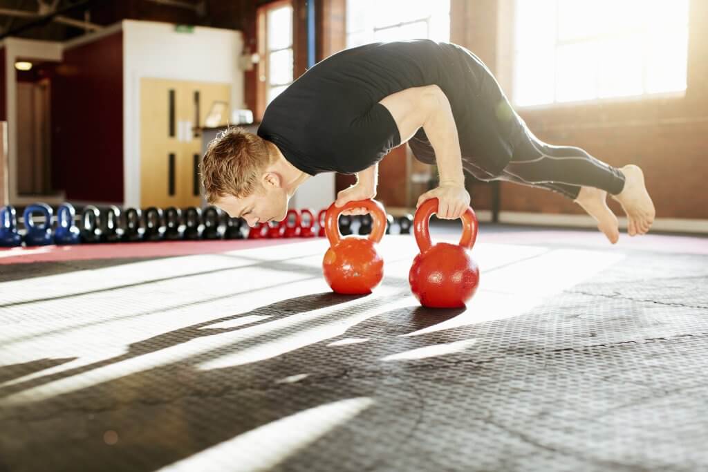 Fitness-Man strength training with kettle bells