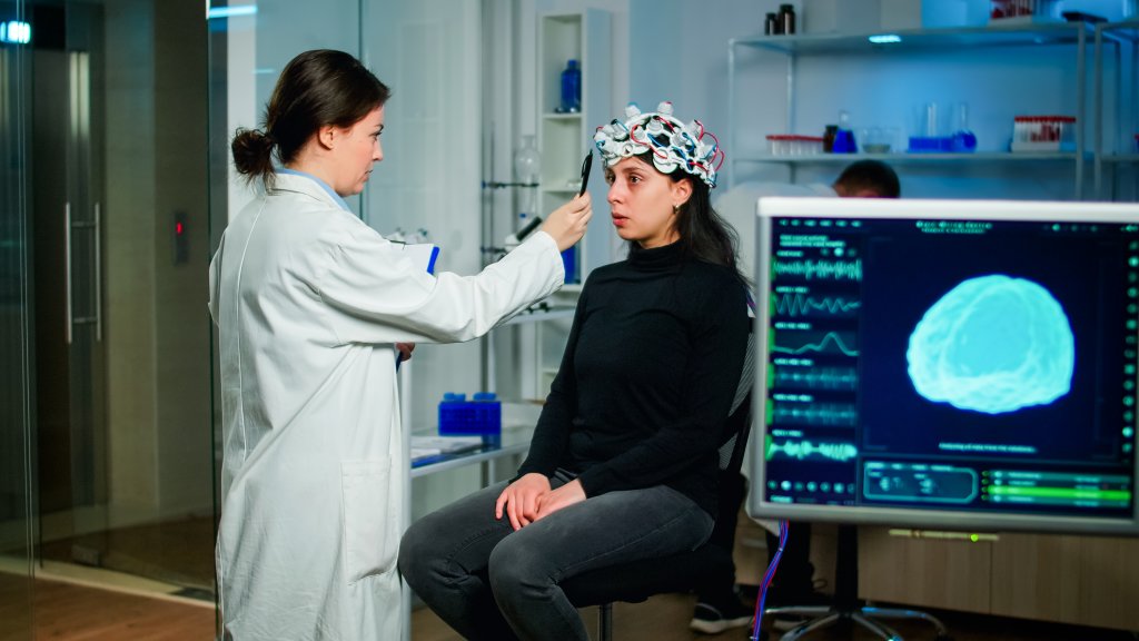 Ketosis-Medical researcher preparing patient for examining brain functions