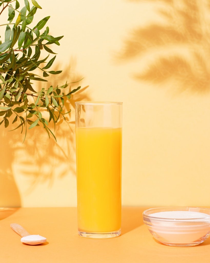 Hydrating Foods-Orange juice glass and collagen powder