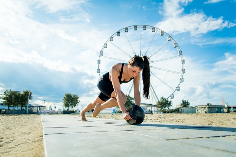 Sportive girl training on the beach
