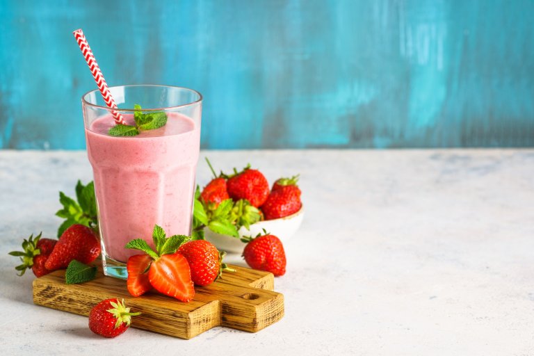Strawberry smoothie or milkshake on white.