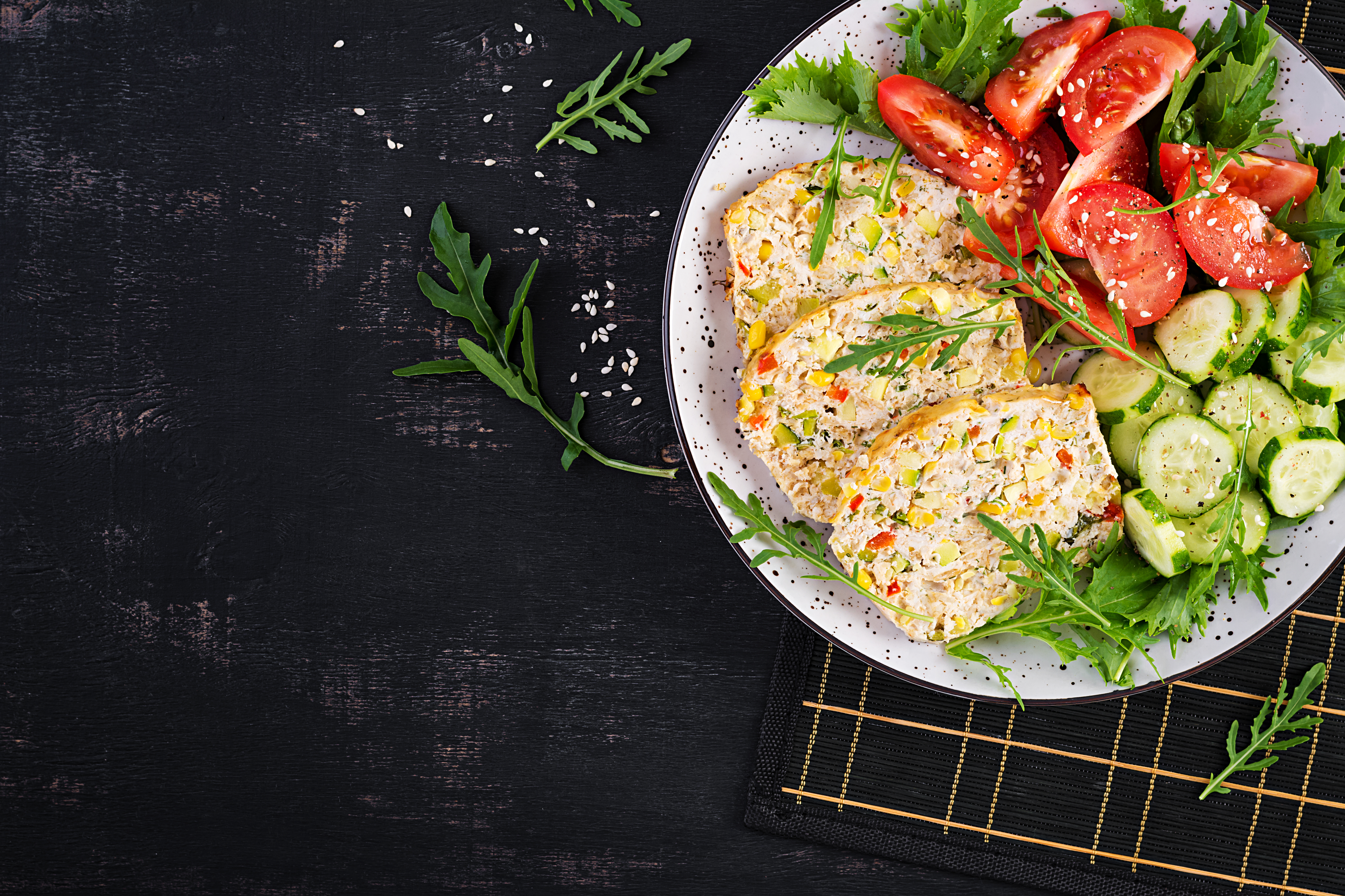 Trendy salad. Chicken meatloaf with salad fresh tomatoes and cucumber.