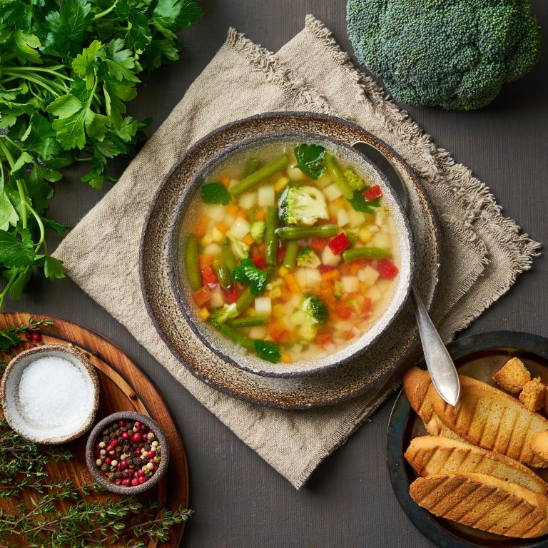 Vegetable soup, dietary vegetarian bright spring dish, linen napkin, top view,
