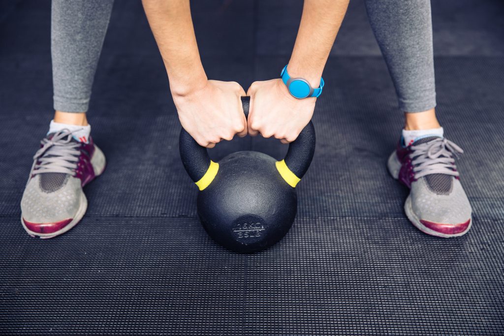 Physical Activity and Heart Health-Woman working out with kettle ball
