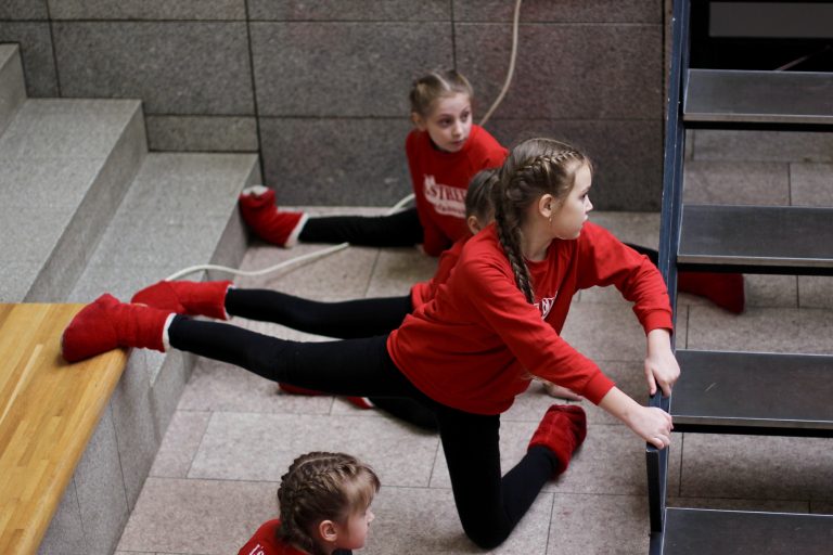 Young little girls in sportive wear stretch before a dance competition. flexibility