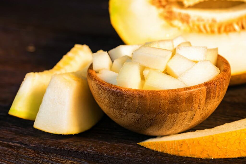 Chopped melon in a wooden bowl close